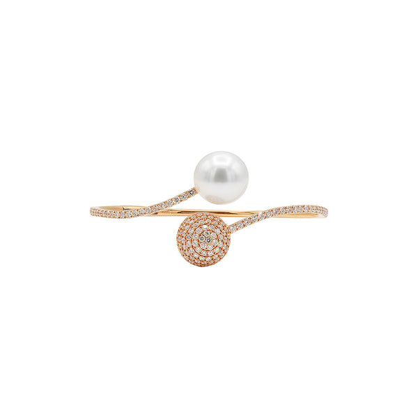A luxurious pearl and diamond bracelet on a gold tone band